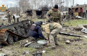 98476432_State-Emergency-Service-members-collect-ordnance-after-Russias-withdrawal-from-the-area-in